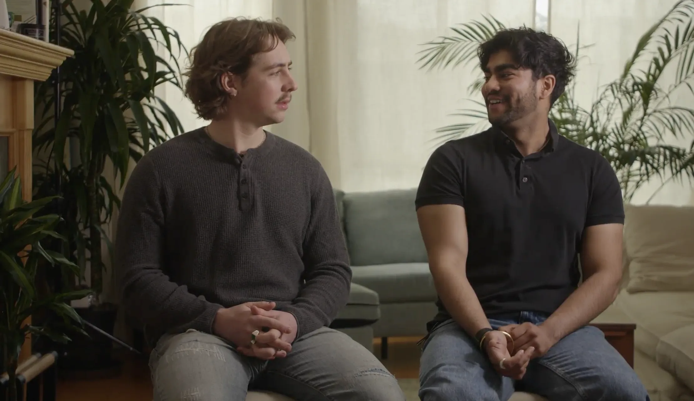 Two founders sitting side by side during a video interview in a plant-filled living room